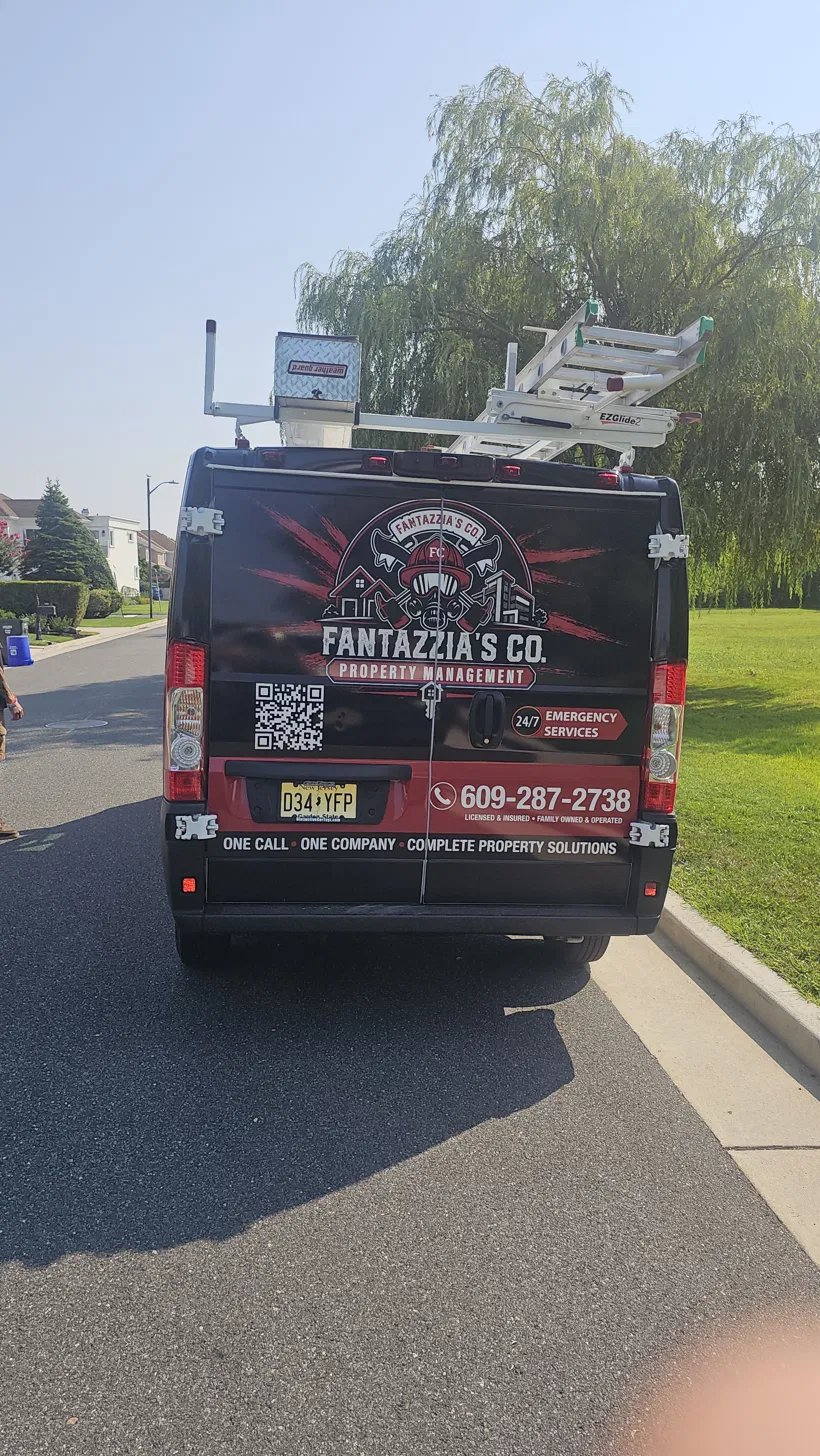 Rear of the wrapped Fantazzia's Co. van showing the crest and phone number